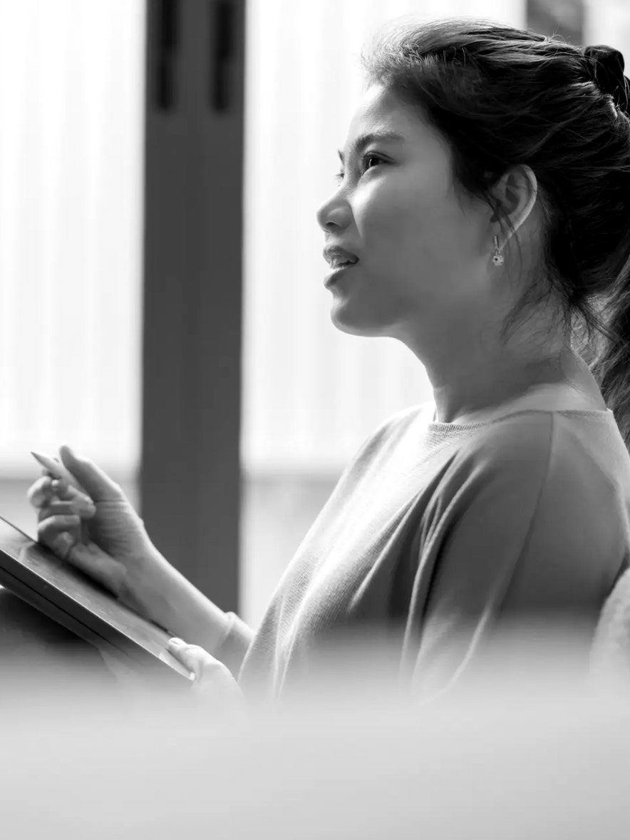 An Executive Assistant taking notes in a meeting